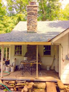 old house in the wood with stone chimney