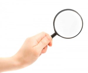 hand holding a magnifier