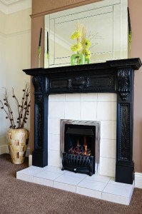 white tile fireplace with wooden design mantel
