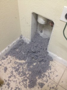 dirty dryer vent with a pile of lint and debris