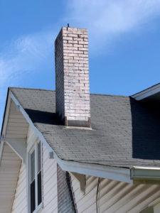 a white chimney against the blue sky