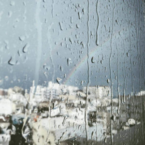 rainbow and rain outside a window