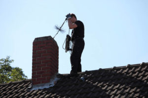 chimney sweep on roof 